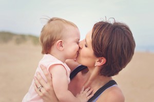 Sharon and her smiling baby kiss.